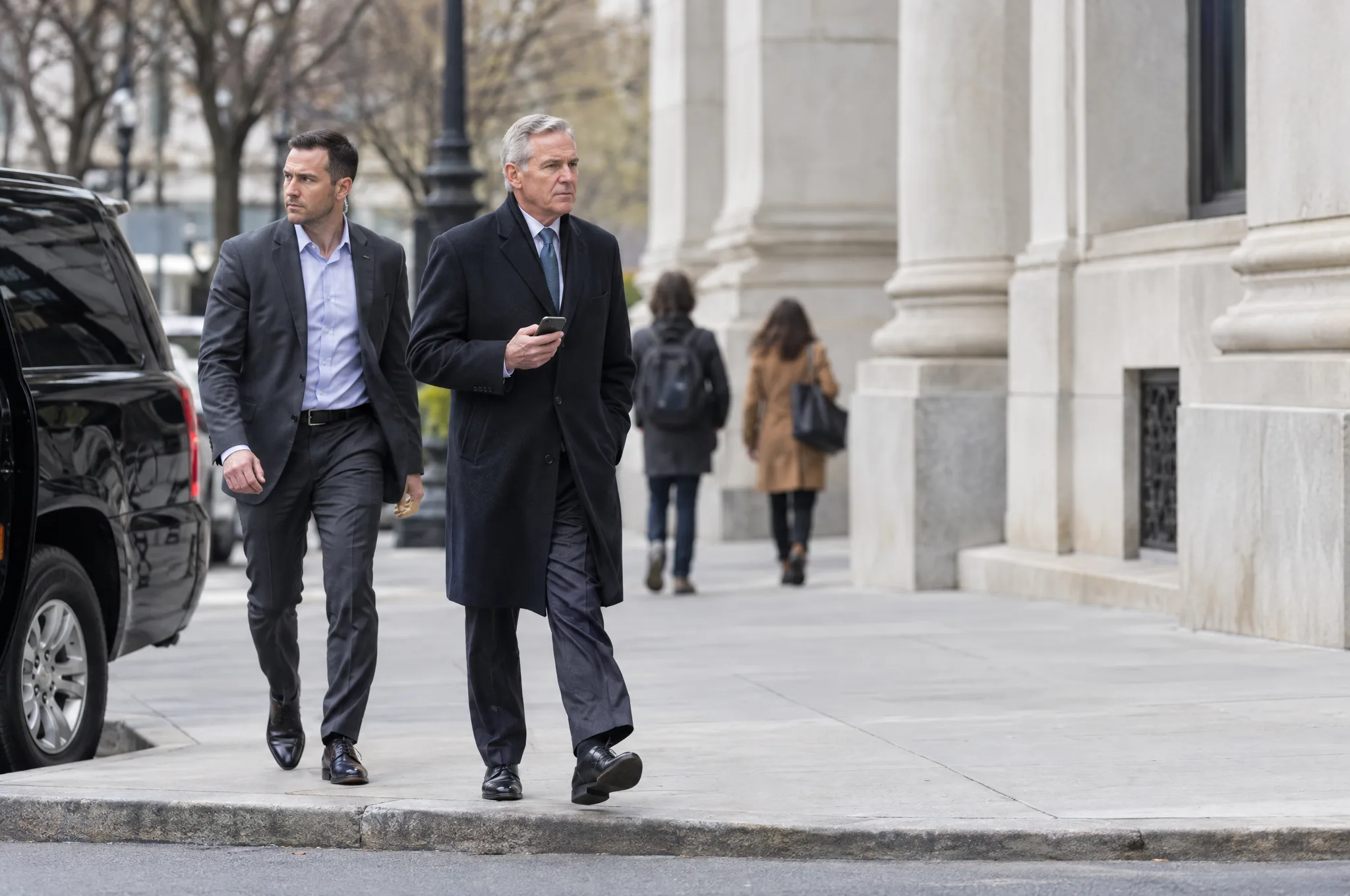 Executive Protection Agent walking alongside a senior executive on a Washington, DC sidewalk beside a black SUV
